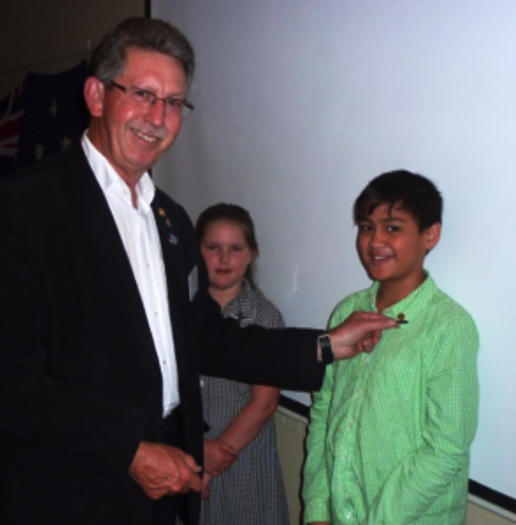 Junior Community Awards. A student receiving his Junior Community Pin